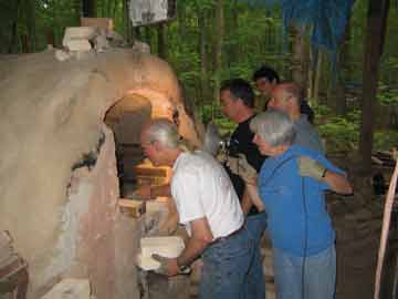 The crew peaks into the kiln door before unloading.